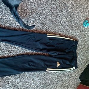 Gold and black adidas sweats with flared zip up ends